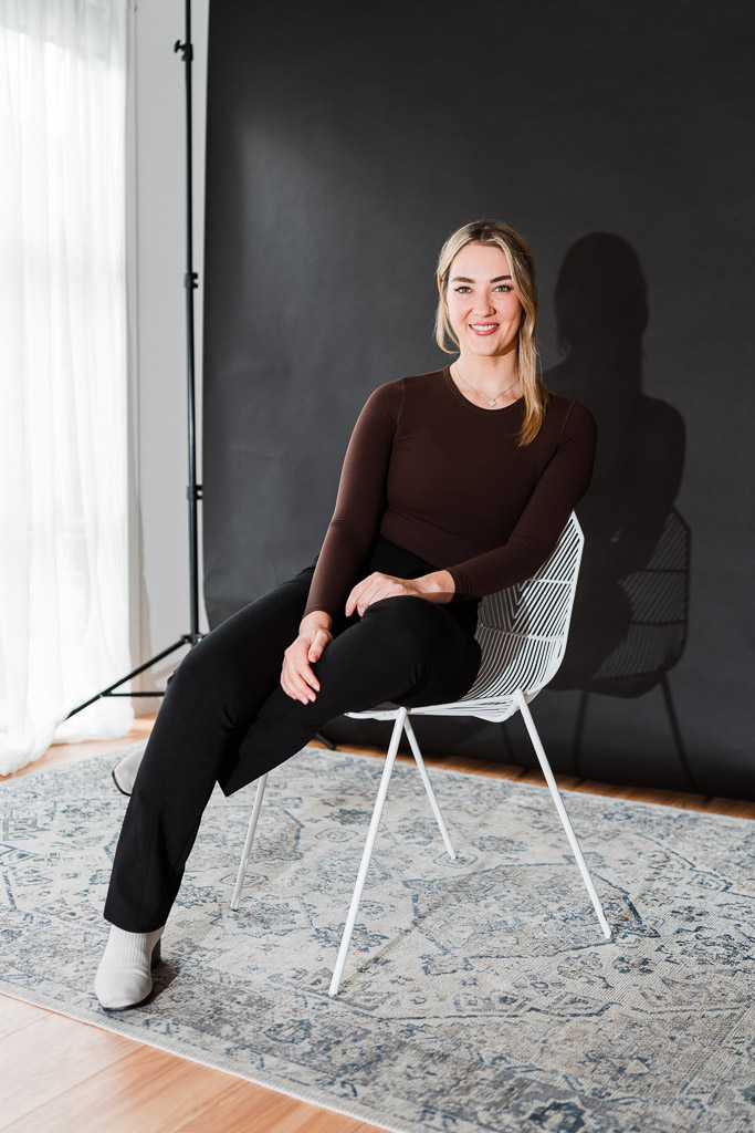 Modern personal brand portrait using flash photography on a black backdrop at Wonderferris’ Kumeu pop-up studio.