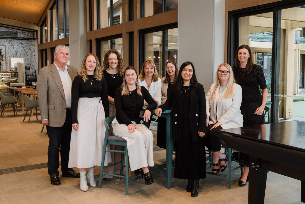 Modern Auckland business brand photography of Martin & Parker Law team gathered at a Silverdale café.