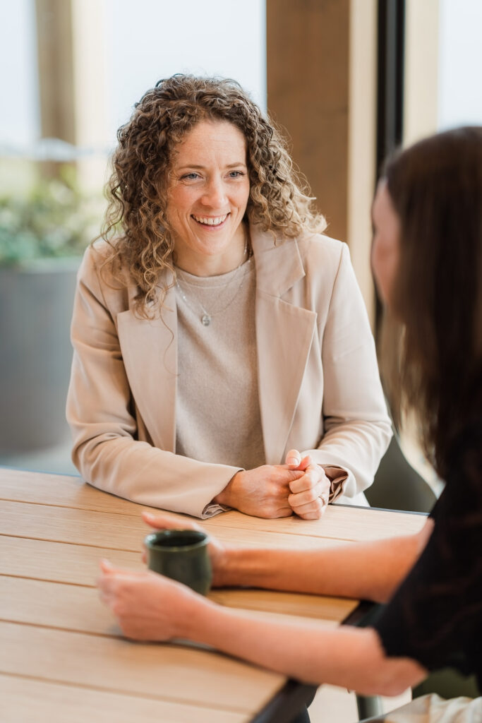 Candid content photo of Martin & Parker Law staff interacting and discussing work in a Silverdale café.