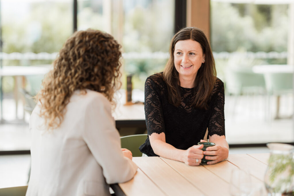 Staff interaction shot showcasing teamwork and professionalism during an Auckland brand photography session.