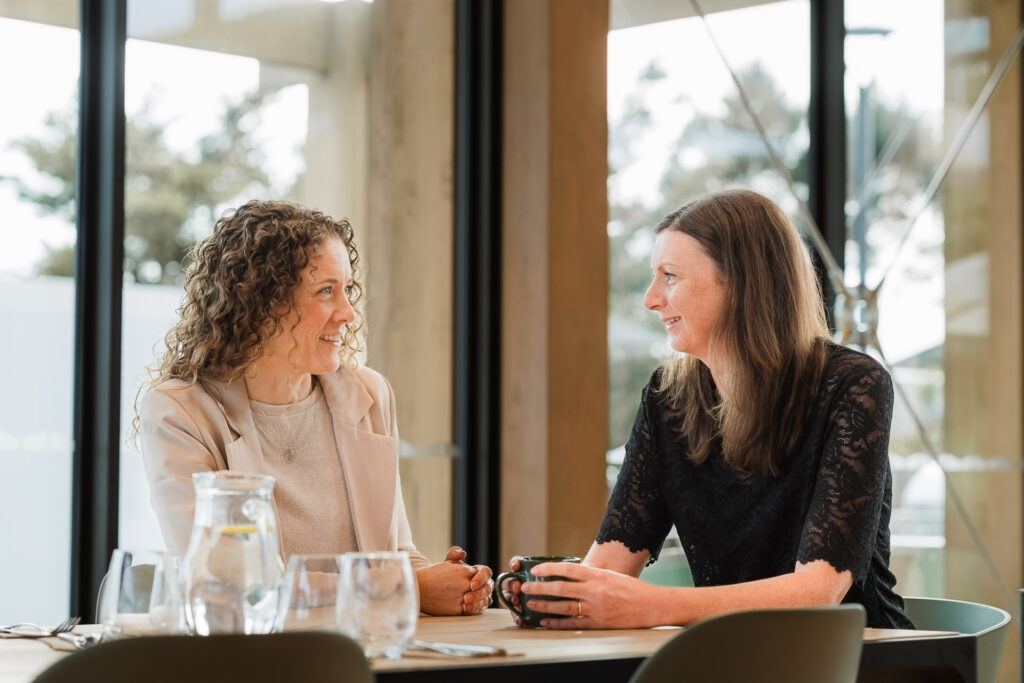 Team members of Martin & Parker Law collaborating over coffee in a modern Silverdale café setting.