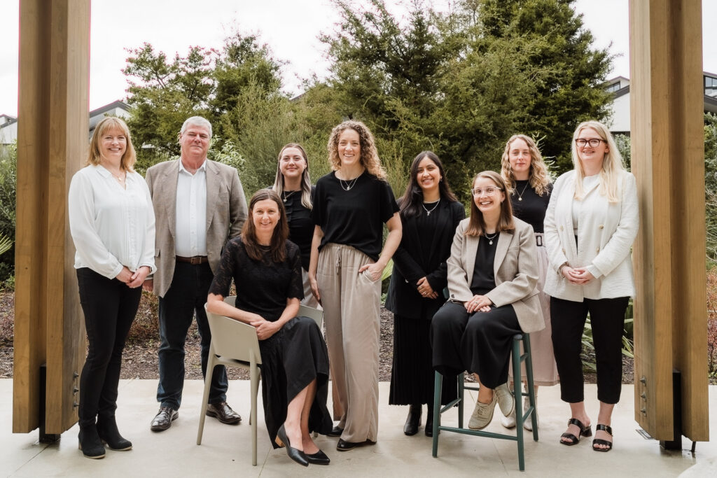 Formal team photo of Martin & Parker Law staff captured by Wonderferris in an outdoor Silverdale café setting.