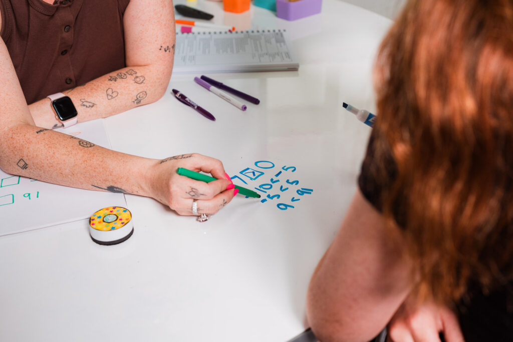 Children interacting with educational products in front of a screen, part of Auckland content photography for Mrs Priestly.