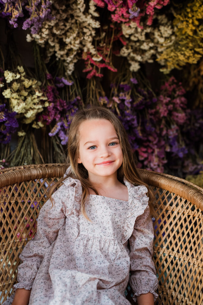 Toddler sitting independently in a dried flower setting during a Wonderferris mini session in West Auckland.