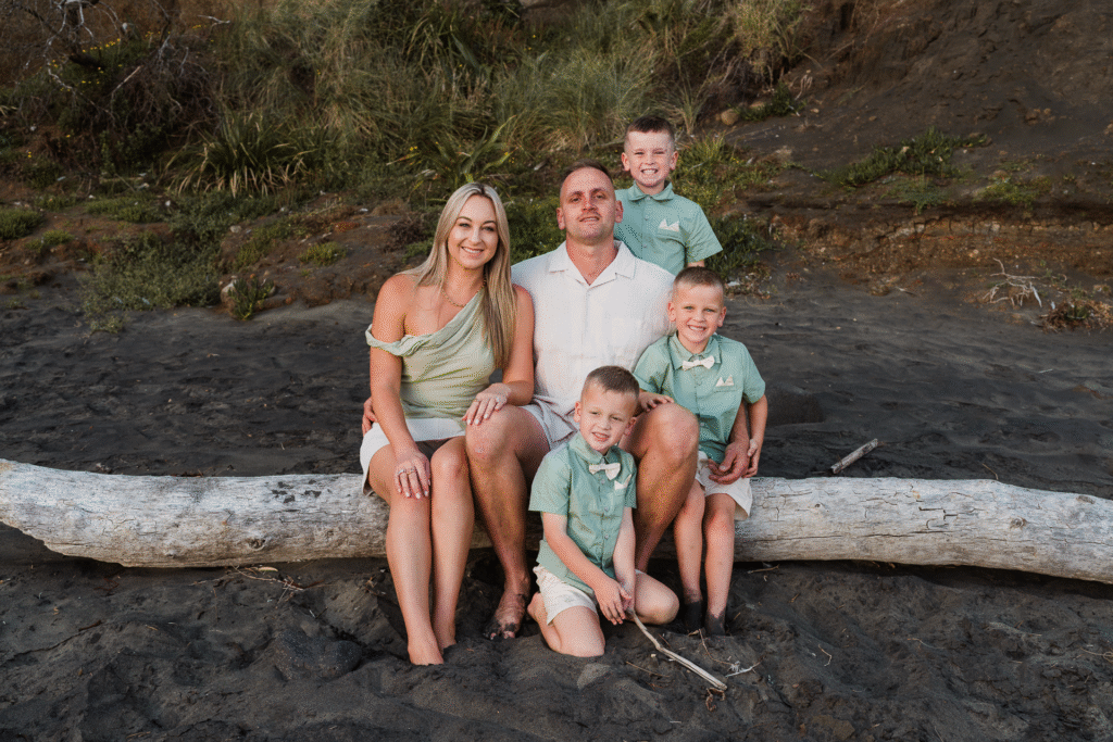 Candid family portrait with soft light at Maori Bay, part of an Auckland mini session by Wonderferris.