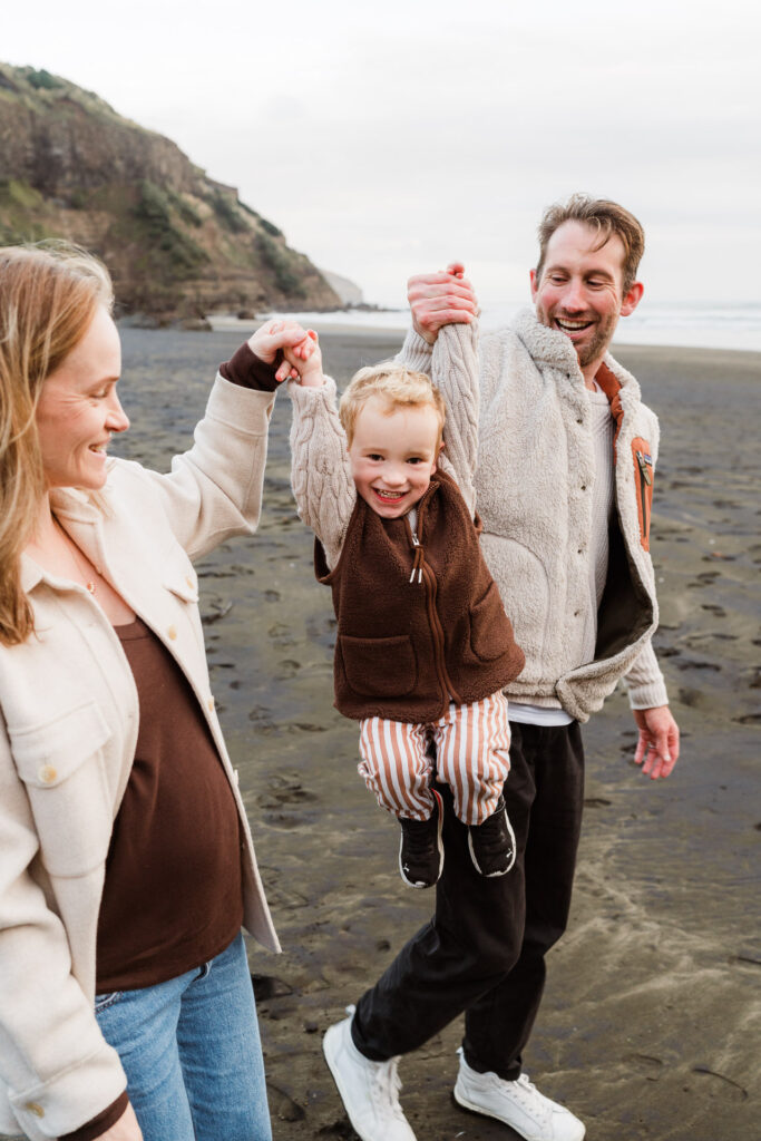 Silhouetted family walking together during golden hour beach mini session by Wonderferris.