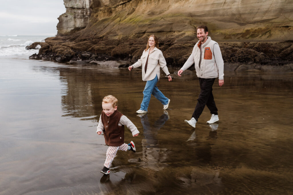 Family group photo during a golden hour beach mini session at Muriwai, photographed by Wonderferris.