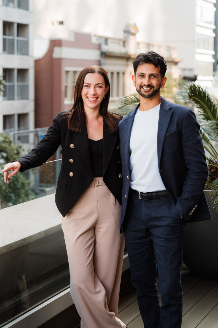 Two Co Legal team members standing together on an Auckland CBD rooftop, captured by Wonderferris for corporate brand photography.