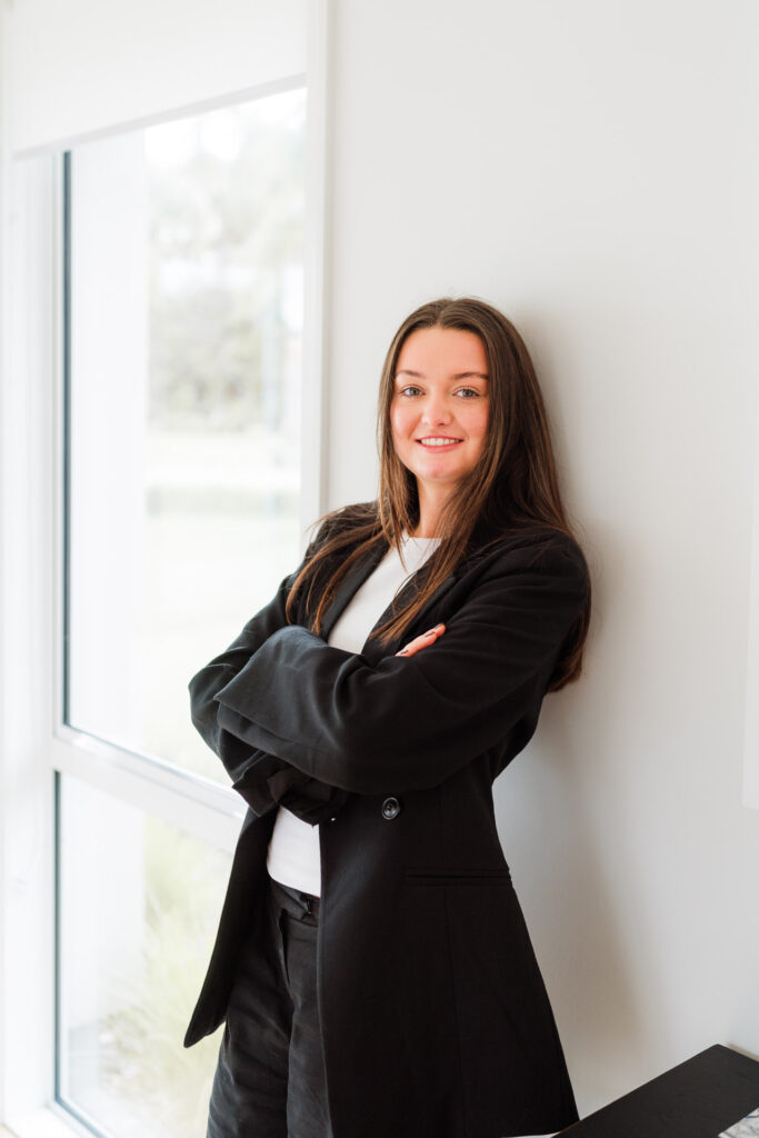 Edgy professional portrait of a Make It Happen team member, shot with natural lighting in a modern home office.