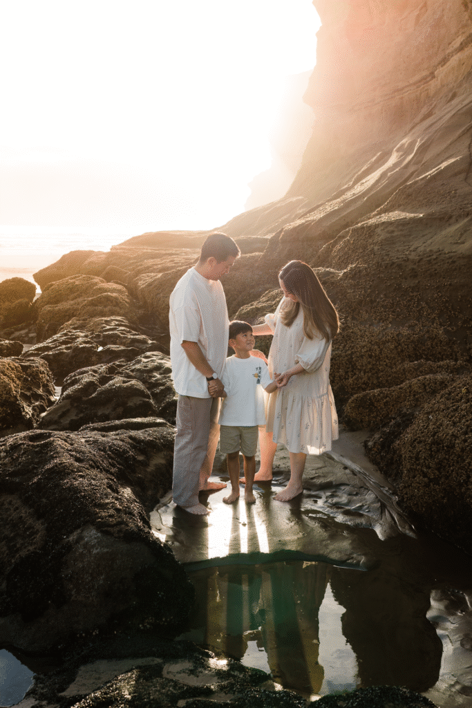 Couple and kids walking toward the waves at Maori Bay, photographed during a seasonal mini shoot.