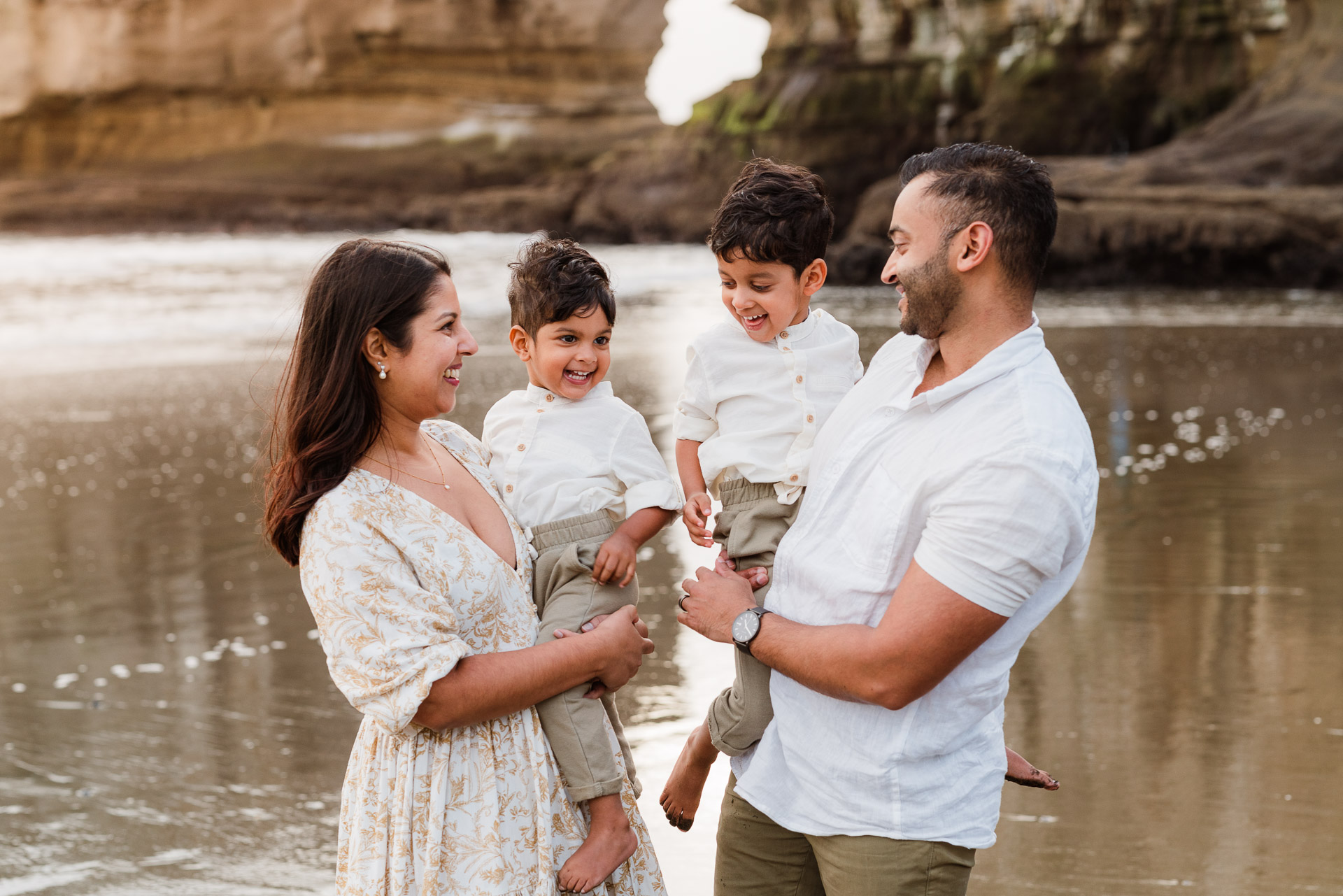 Full family portrait during a beach mini session at Muriwai, captured at golden hour by Wonderferris.