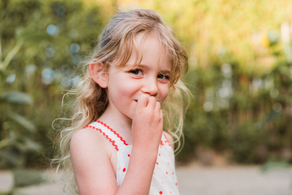 Sweet portrait of a girl surrounded by sunflowers at Franklin Farms, photographed in West Auckland by Wonderferris.