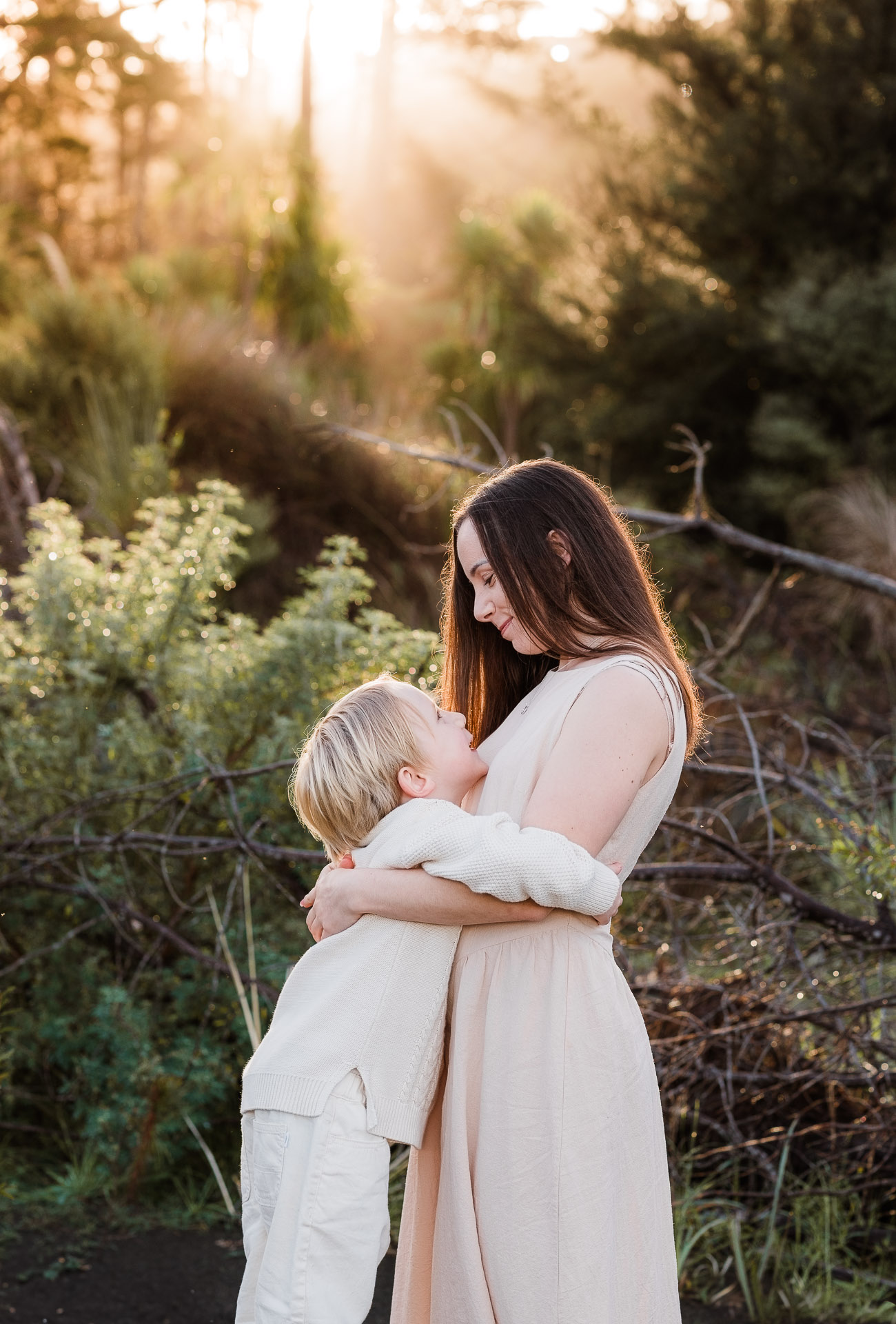 Mum and son at golden hour for photoshoot at Bethells Lake