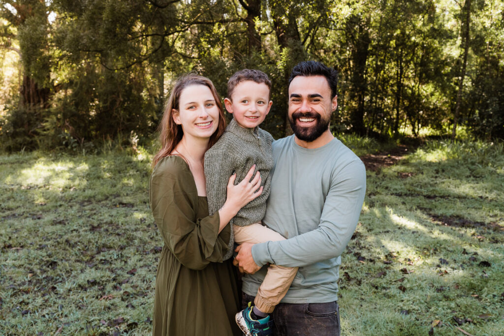 Natural couple portrait with tall trees in the background, taken by Wonderferris in Kumeu